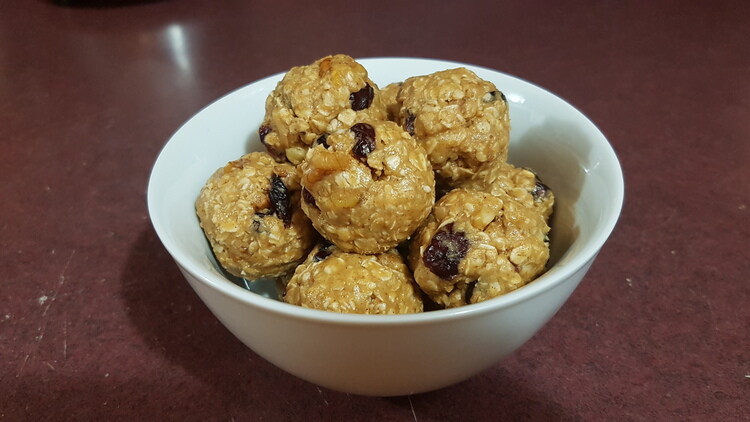 Cranberry Walnut Protein Bites Sitting In a Bowl on a Counter