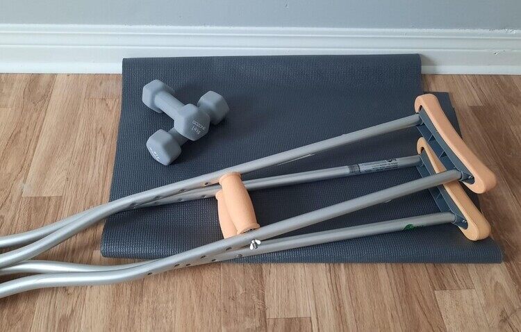 Crutches, barbells and a yoga mat. Lose Weight with an Injury