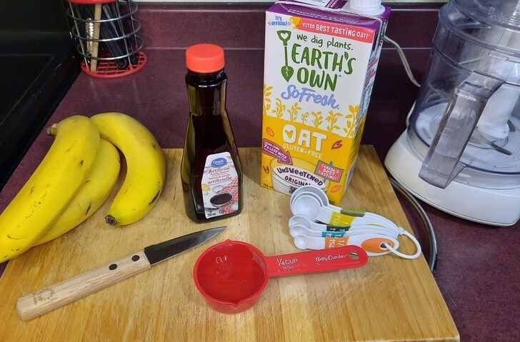 Banana "Nice" Cream Ingredients on a wooden cutting board