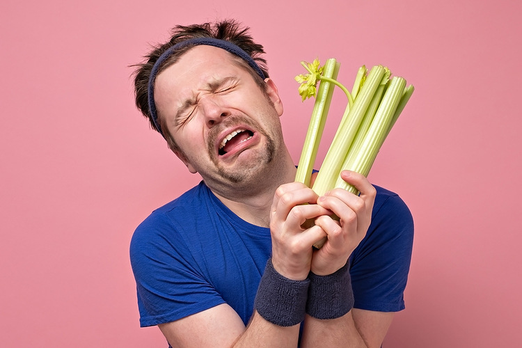 Man Holding Celery Crying. Tips on How to Lose Weight Healthily