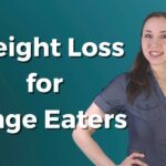 Weight Loss for Binge Eaters Logo. Main course picture for Weight Loss for Binge Eaters mini-course. It features the title in bold white letters next to a picture of Ang. She's wearing a navy blue blouse and has long, wavy brown hair. She has her hand on her hip and is smiling. The background is a gradient between dark and medium blue-green.